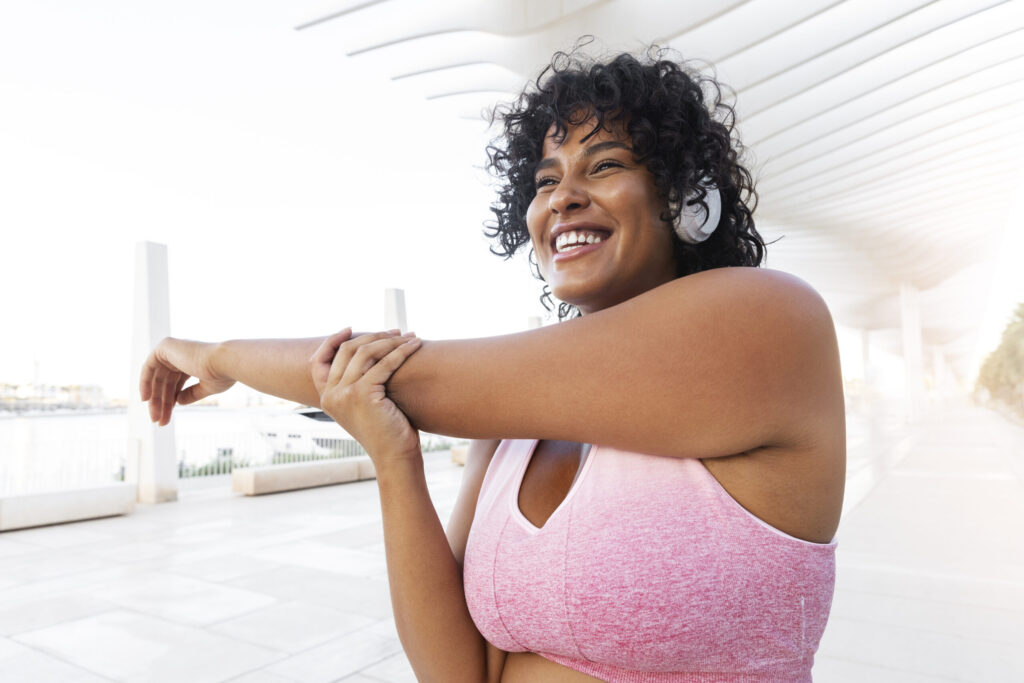 side view woman stretching arm scaled.jpg